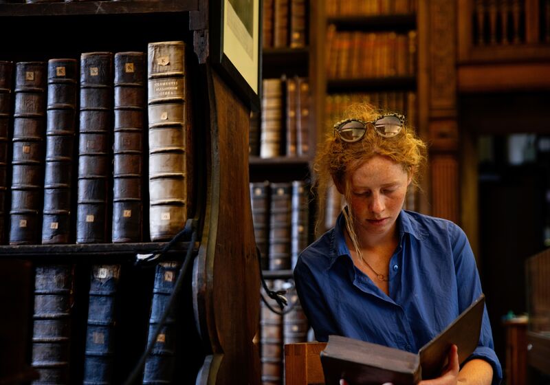 Student at Queens' College library