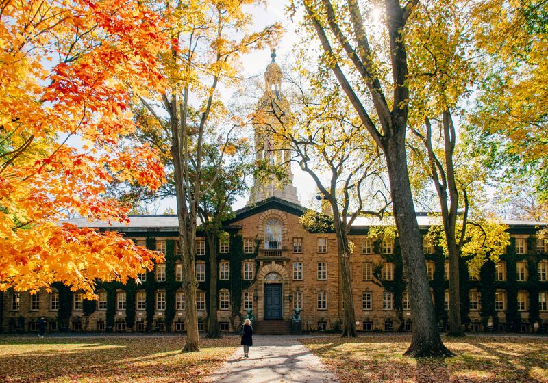 Person walking in front of building of the University of Princeton